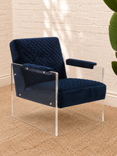 Load image into Gallery viewer, Lucian navy blue velvet accent chair with diamond-quilted upholstery, padded armrests and clear acrylic legs.
