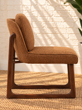 Load image into Gallery viewer, Lucy cushioned dining chair in cinnamon basketweave upholstery with a rounded sculptural back and rubber wood details.
