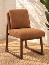 Load image into Gallery viewer, Lucy cushioned dining chair in cinnamon basketweave upholstery with a rounded sculptural back and rubber wood details.
