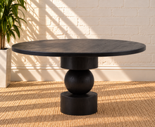 Load image into Gallery viewer, Mabel charcoal reclaimed pine round dining table with stacked cylindrical and spherical sculptural pedestal base.
