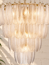 Load image into Gallery viewer, Maine chandelier with cascading tiers of elongated textured clear glass pieces suspended from an iron frame and chain.
