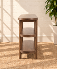 Load image into Gallery viewer, Malie dark walnut open shelf console with rounded ends, two open lower shelves and slender vertical wood supports.
