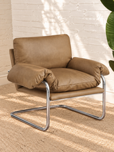 Load image into Gallery viewer, Mara tan vegan leather lounge chair with oversized cushions and polished chrome cantilever frame
