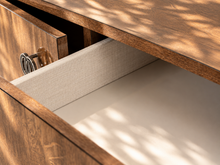 Load image into Gallery viewer, Maren Italian four-door credenza with gloss-finished rovere wood grain, center drawer, and chrome and black C-shaped hardware.
