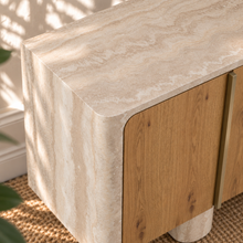 Load image into Gallery viewer, Marlee four-door credenza with natural oak veneer doors, faux travertine surround, interior shelving, and two rounded pedestal legs.
