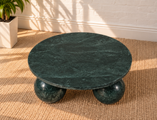 Load image into Gallery viewer, Martha round Forest Night marble coffee table with three spherical ball-shaped bases and natural dark green stone veining.
