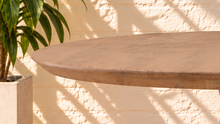 Load image into Gallery viewer, Micah natural mango wood round dining table with circular top and sculptural tapered pedestal base.
