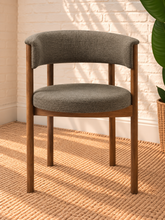 Load image into Gallery viewer, Mila mocha upholstered dining chair with curved open back, round cushioned seat, warm wood frame, and cylindrical legs
