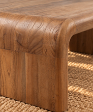 Load image into Gallery viewer, Molly natural brown mindi wood coffee table with rounded rectangular top and wide waterfall-style legs.
