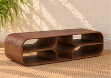 Load image into Gallery viewer, Montana natural brown mindi wood coffee table with a rectangular top, rounded corners, visible wood grain, and sculptural curved base.
