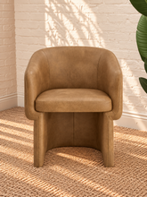 Load image into Gallery viewer, Nadia tan pebbled vegan leather dining armchair with rounded barrel back, sloped arms, cushioned seat, and fully upholstered base
