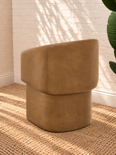 Load image into Gallery viewer, Nadia tan pebbled vegan leather dining armchair with rounded barrel back, sloped arms, cushioned seat, and fully upholstered base
