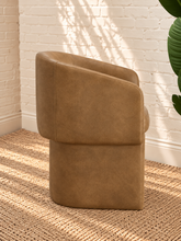 Load image into Gallery viewer, Nadia tan pebbled vegan leather dining armchair with rounded barrel back, sloped arms, cushioned seat, and fully upholstered base
