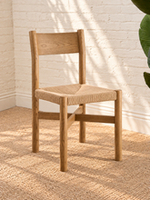 Load image into Gallery viewer, Amelie natural solid oak dining armchair with woven paper-rope seat, curved wood backrest, slim armrests, and X-shaped stretcher
