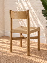 Load image into Gallery viewer, Amelie natural solid oak dining armchair with woven paper-rope seat, curved wood backrest, slim armrests, and X-shaped stretcher
