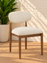 Load image into Gallery viewer, Nancy dining chair upholstered in Oat Milk performance fabric with Brown Walnut Ash Wood frame and brushed brass accents
