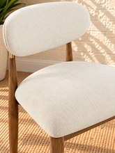 Load image into Gallery viewer, Nancy dining chair upholstered in Oat Milk performance fabric with Brown Walnut Ash Wood frame and brushed brass accents
