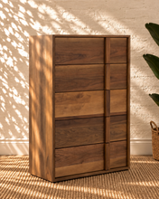 Load image into Gallery viewer, Nixon five-drawer dresser in warm walnut veneer with natural wood grain and integrated vertical wood pulls.
