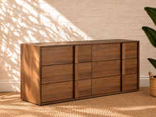 Load image into Gallery viewer, Nixon six-drawer dresser in warm walnut veneer with integrated vertical wood pulls and natural wood grain drawer fronts.
