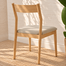 Load image into Gallery viewer, Nola dining chair with natural rubberwood frame, gray upholstered seat, curved wood backrest, and tapered legs
