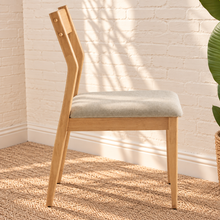 Load image into Gallery viewer, Nola dining chair with natural rubberwood frame, gray upholstered seat, curved wood backrest, and tapered legs
