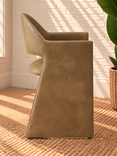 Load image into Gallery viewer, Nora tan vegan leather dining armchair with curved barrel back, open-back detail, padded seat, and wide upholstered sides

