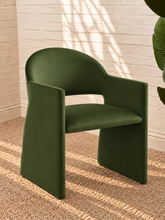 Load image into Gallery viewer, Nora olive green velvet dining armchair with curved barrel back, open-back design, angular arms, and upholstered panel base
