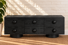 Load image into Gallery viewer, Norris Charcoal buffet credenza with oversized orb knobs, central drawers, cabinet storage, and rounded pedestal base
