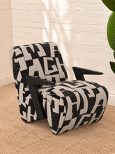 Load image into Gallery viewer, Nyla black and white geometric pattern upholstered accent chair with angular black wood arms and cushioned seat.
