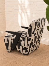 Load image into Gallery viewer, Nyla black and white geometric pattern upholstered accent chair with angular black wood arms and cushioned seat.
