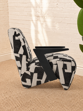 Load image into Gallery viewer, Nyla black and white geometric pattern upholstered accent chair with angular black wood arms and cushioned seat.
