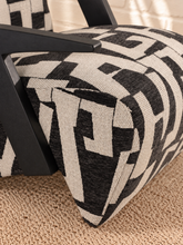 Load image into Gallery viewer, Nyla black and white geometric pattern upholstered accent chair with angular black wood arms and cushioned seat.
