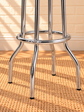 Load image into Gallery viewer, Image 4 of 4: Ortega Chrome Swivel Bar Stool in Crimson Red faux leather with ribbed chrome apron, flared legs, and footrest

