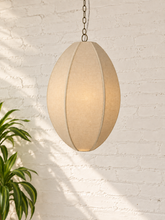 Load image into Gallery viewer, Penny hanging lamp in sand cotton rope with an elongated oval shade, raised vertical ribs, iron frame, and chain suspension.
