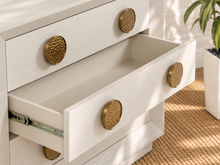 Load image into Gallery viewer, Phoebe three-drawer nightstand in cream white ash veneer with six round textured golden metal handles and recessed plinth base.
