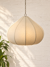 Load image into Gallery viewer, Poppy hanging lamp in sand with a rounded sculptural shade, textured surface, vertical rib detailing, and metal chain suspension.
