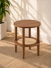 Load image into Gallery viewer, Rayna warm walnut round side table with four cylindrical legs and woven rattan lower shelf
