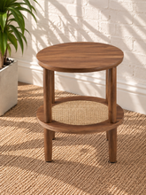 Load image into Gallery viewer, Rayna warm walnut round side table with four cylindrical legs and woven rattan lower shelf
