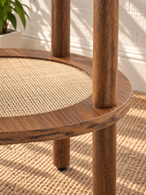 Load image into Gallery viewer, Rayna warm walnut round side table with four cylindrical legs and woven rattan lower shelf
