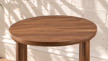Load image into Gallery viewer, Rayna warm walnut round side table with four cylindrical legs and woven rattan lower shelf

