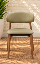 Load image into Gallery viewer, Reed Walnut dining chair upholstered in Desert Khaki vegan leather with curved backrest and solid wood frame
