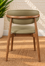 Load image into Gallery viewer, Reed Walnut dining chair upholstered in Desert Khaki vegan leather with curved backrest and solid wood frame
