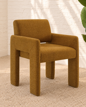 Load image into Gallery viewer, Reese ochre upholstered dining armchair with broad arms, angled legs, padded seat, and rounded backrest
