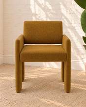 Load image into Gallery viewer, Reese ochre upholstered dining armchair with broad arms, angled legs, padded seat, and rounded backrest
