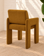 Load image into Gallery viewer, Reese ochre upholstered dining armchair with broad arms, angled legs, padded seat, and rounded backrest
