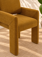 Load image into Gallery viewer, Reese ochre upholstered dining armchair with broad arms, angled legs, padded seat, and rounded backrest
