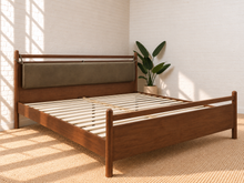 Load image into Gallery viewer, Rocco King platform bed with Walnut rubberwood frame, Taupe faux leather upholstered headboard pillow, and decorative leather straps.
