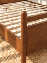Load image into Gallery viewer, Rocco King platform bed with Walnut rubberwood frame, Taupe faux leather upholstered headboard pillow, and decorative leather straps.
