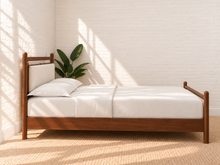 Load image into Gallery viewer, Rocco Queen platform bed with Walnut rubberwood frame, Greige heathered fabric headboard pillow, and faux leather straps. 
