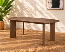 Load image into Gallery viewer, Rohan 79-inch oval dining table in dark walnut solid Mindi wood with rounded tabletop edges and architectural panel legs.
